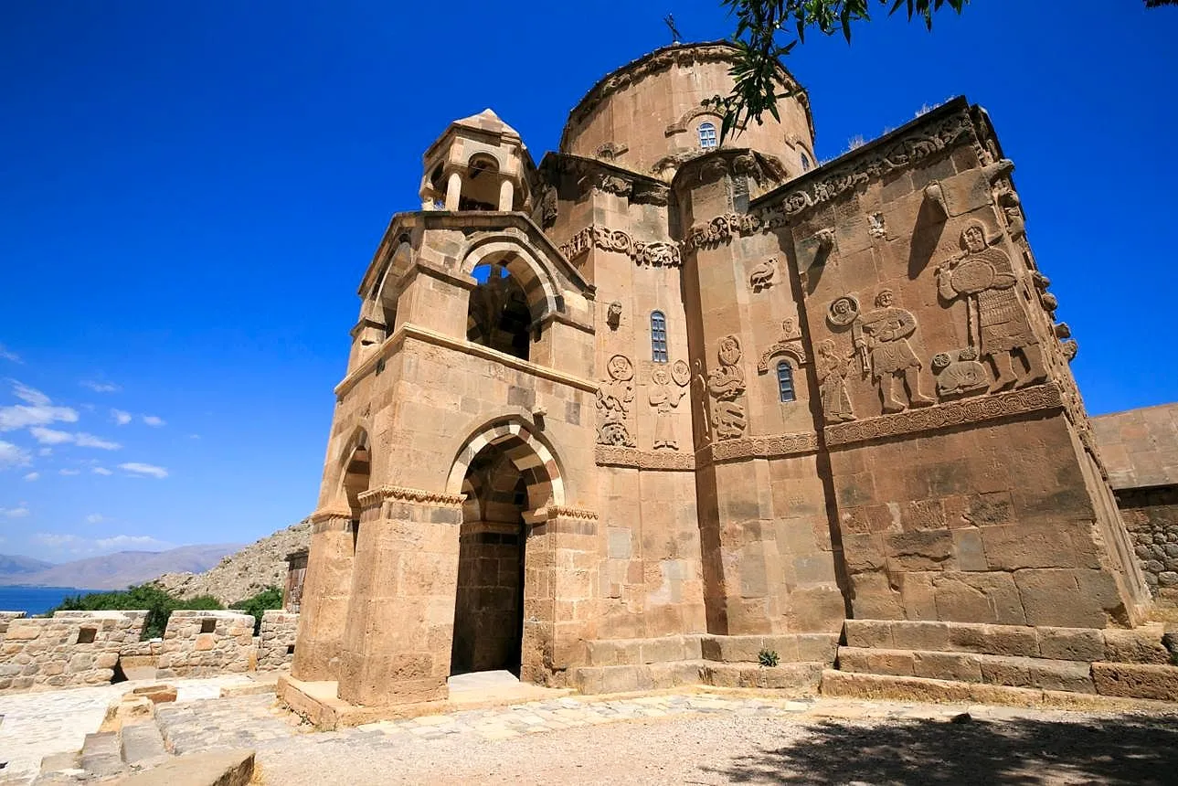 The Church of the Holy Cross on Akdamar Island under a deep blue sky