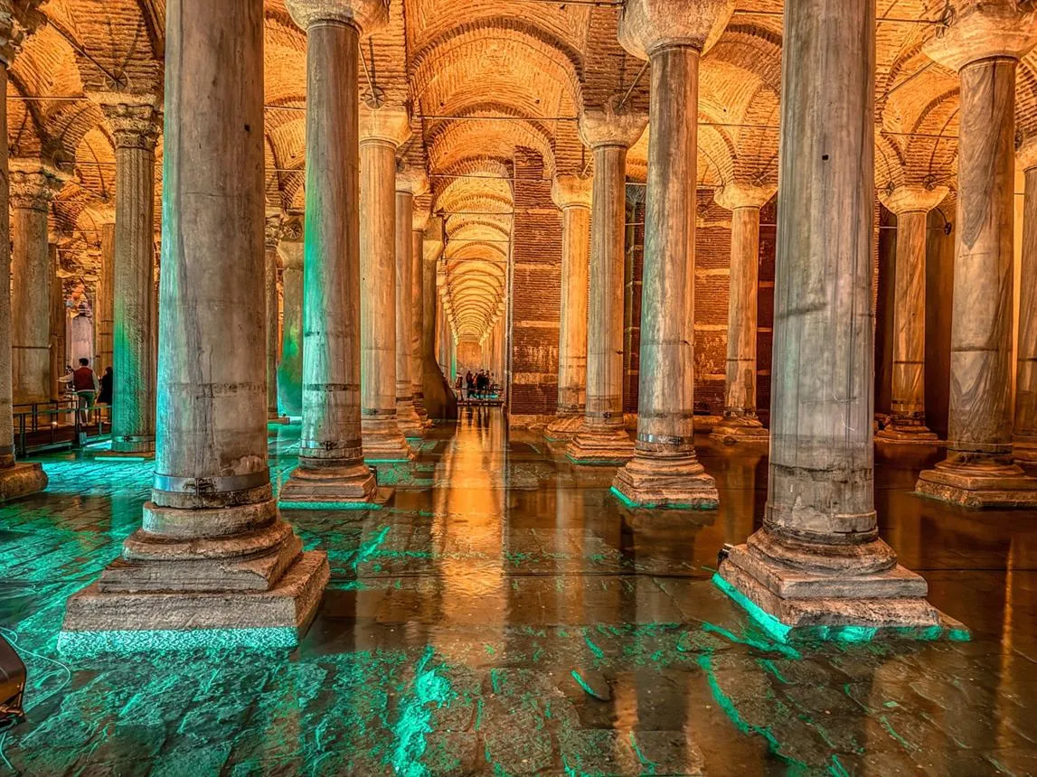 Rows of lit marble columns inside the Basilica Cistern