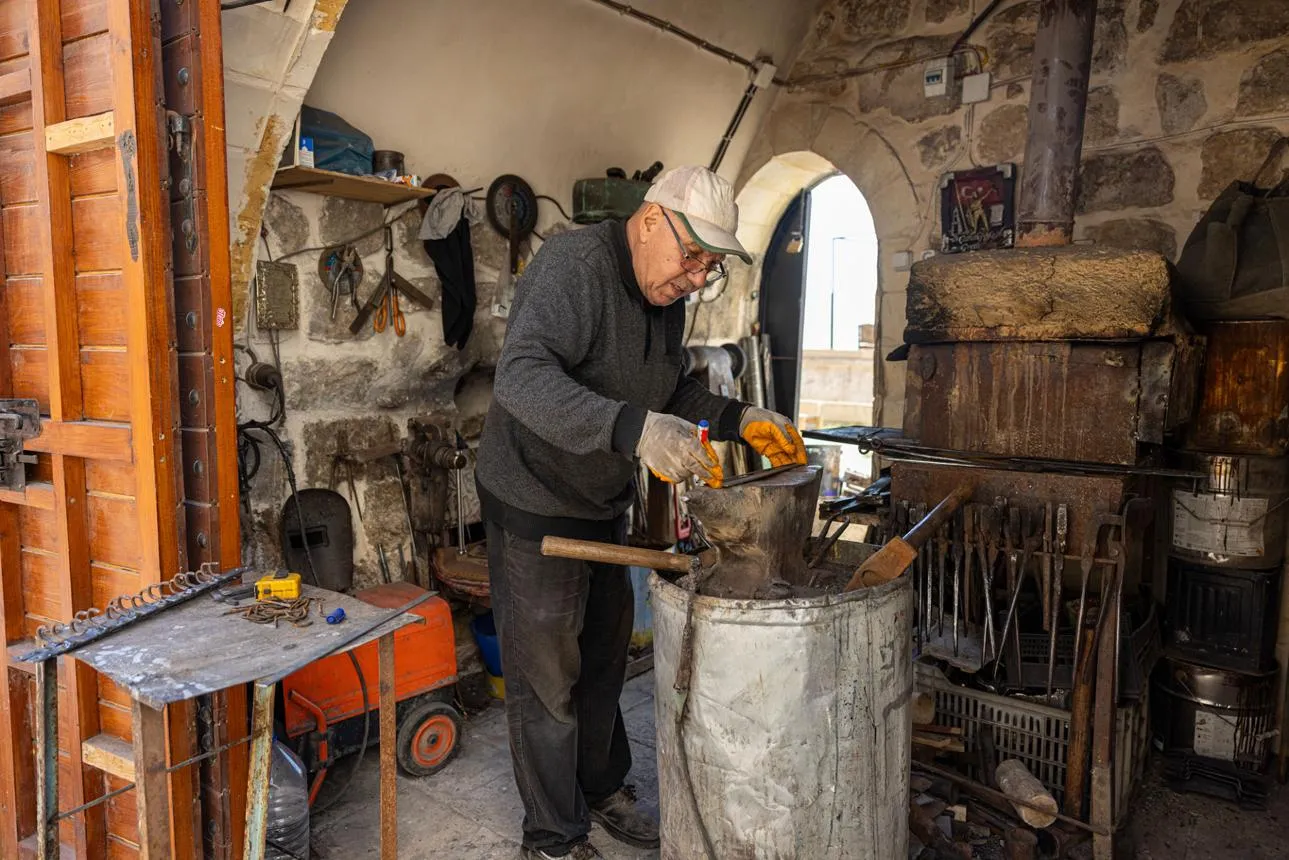 A blacksmith at work in his small workshop in Mardin's old bazaar