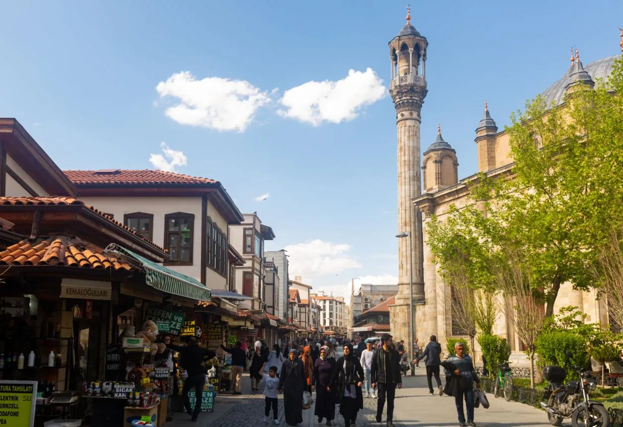 Shops and shoppers in Konya's old bazaar beside the minaret of the Aziziye Mosque