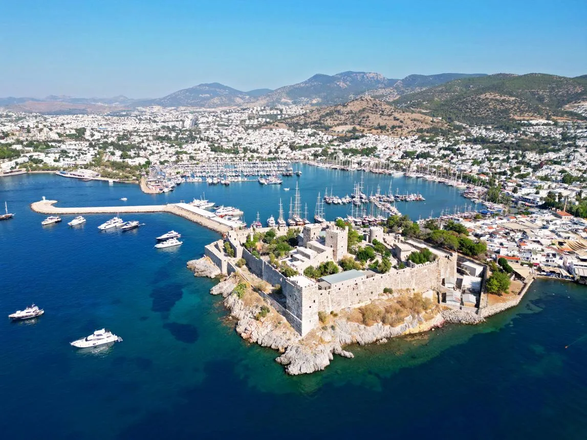 Aerial view of Bodrum Castle on its rocky point, with the marina and the town behind