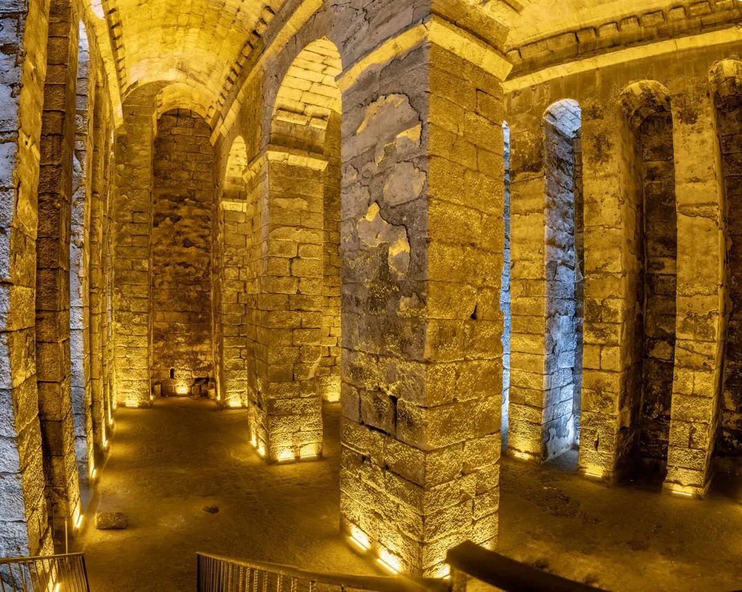 The lit stone arches of the great underground cistern at Dara
