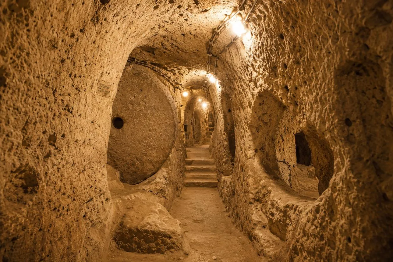 A tunnel in Derinkuyu Underground City with a round rolling stone door