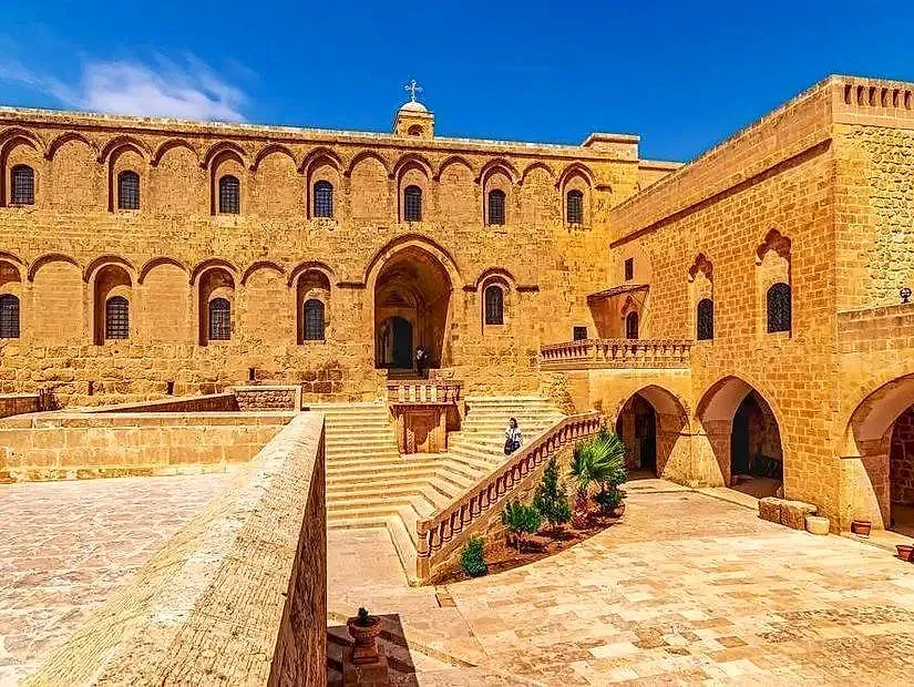 The honey-coloured stone façade and stairways of Deyrulzafaran Monastery