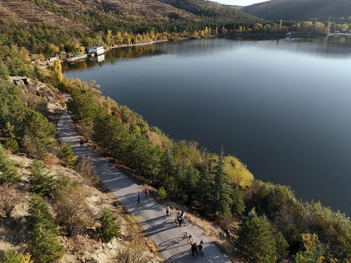 Aerial view of Eymir Lake and the path along its wooded shore in autumn