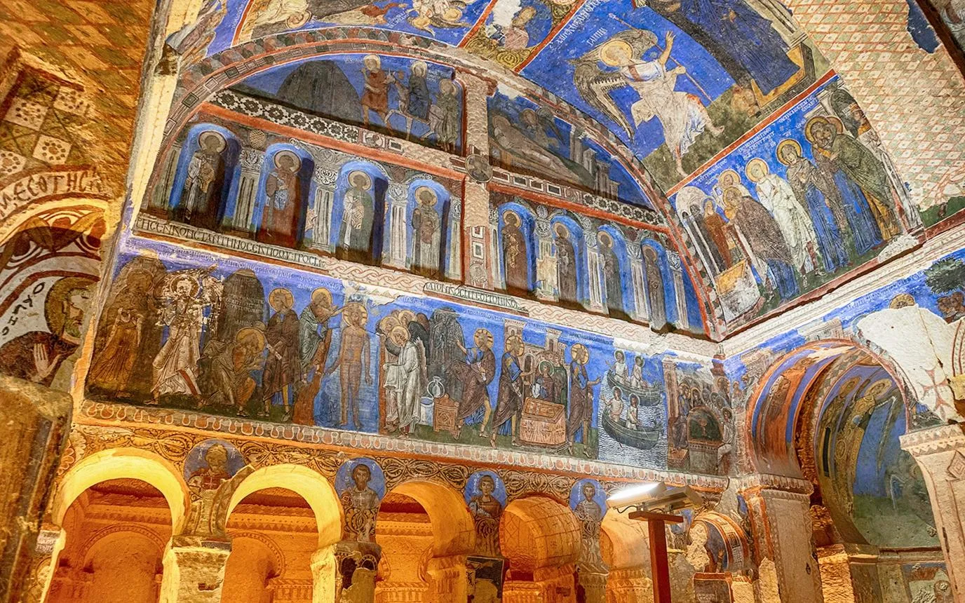 Byzantine frescoes in deep blue and gold inside a rock-cut church at Göreme
