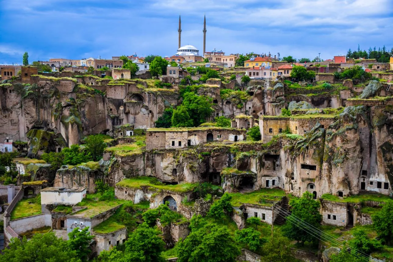 Stone houses and cave dwellings of Güzelyurt below a mosque