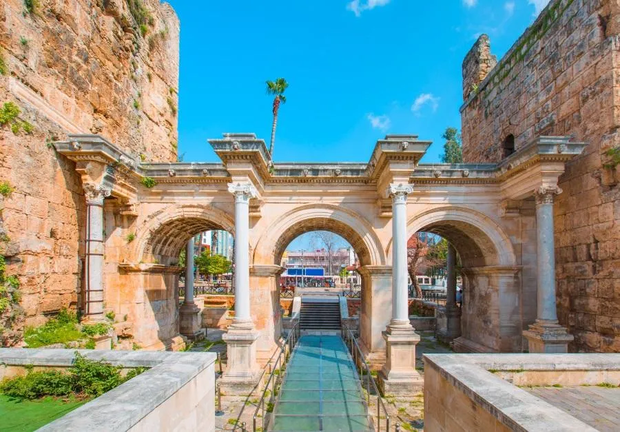 The three marble arches of Hadrian's Gate between two stone towers