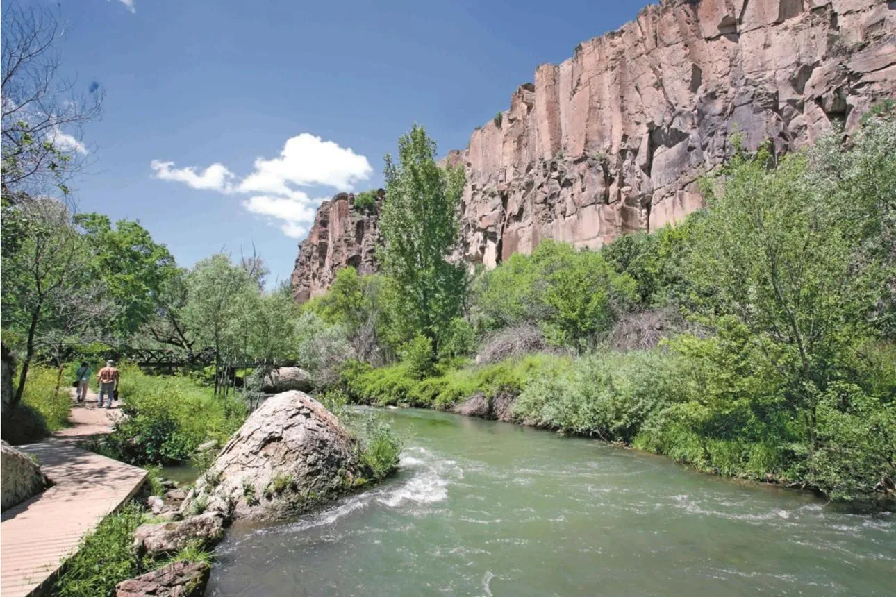 The Melendiz River and a walking path below the cliffs of Ihlara Valley