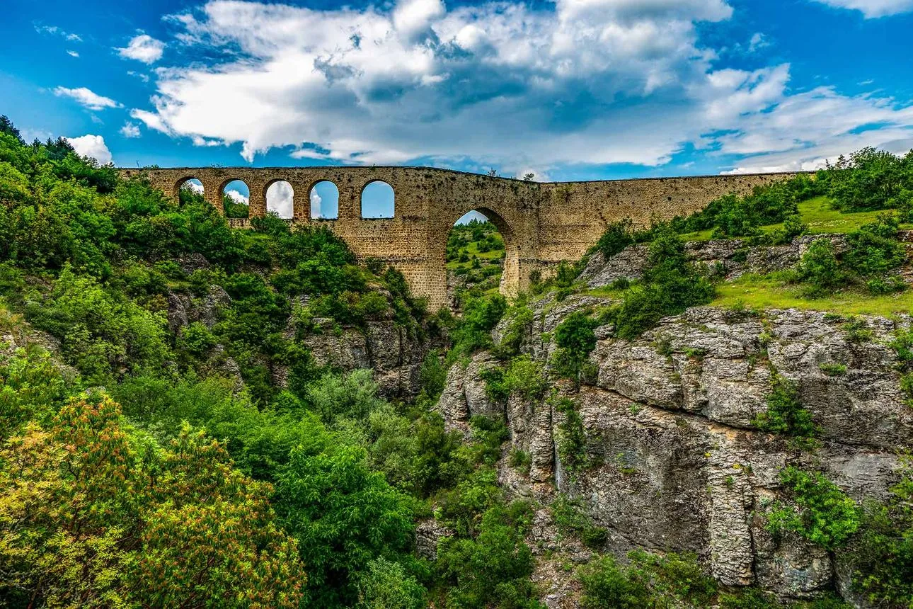 The arched stone İncekaya Aqueduct spanning a green canyon