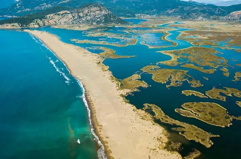 Aerial view of İztuzu's long sand bar between the sea and the reed beds of the delta