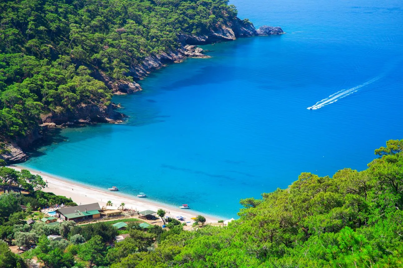 The forested hills and turquoise water of Kabak Bay from above