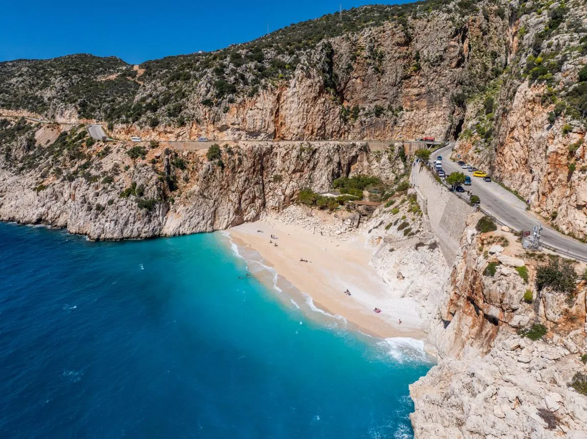 Kaputaş beach and its turquoise water below the cliffs and the coast road
