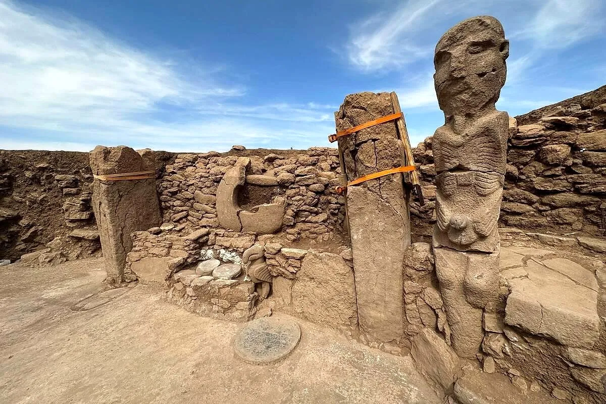 A carved stone figure among the pillars of Karahantepe