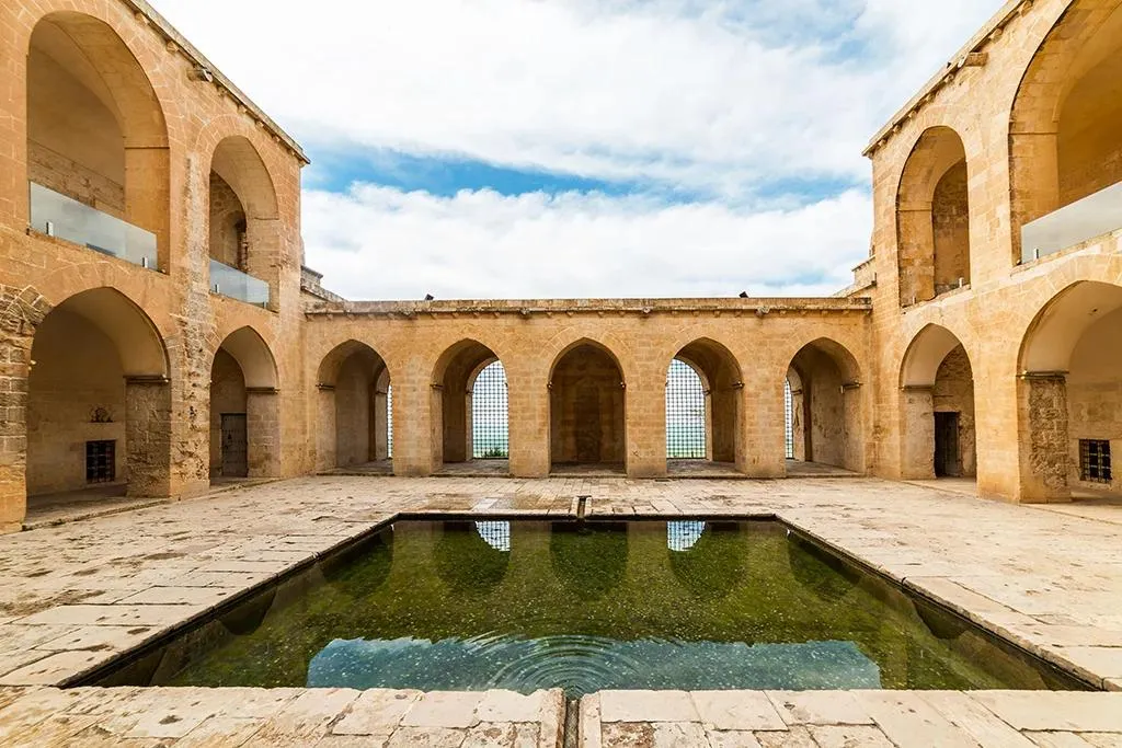 The arcaded courtyard and pool of the Kasımiye Madrasa