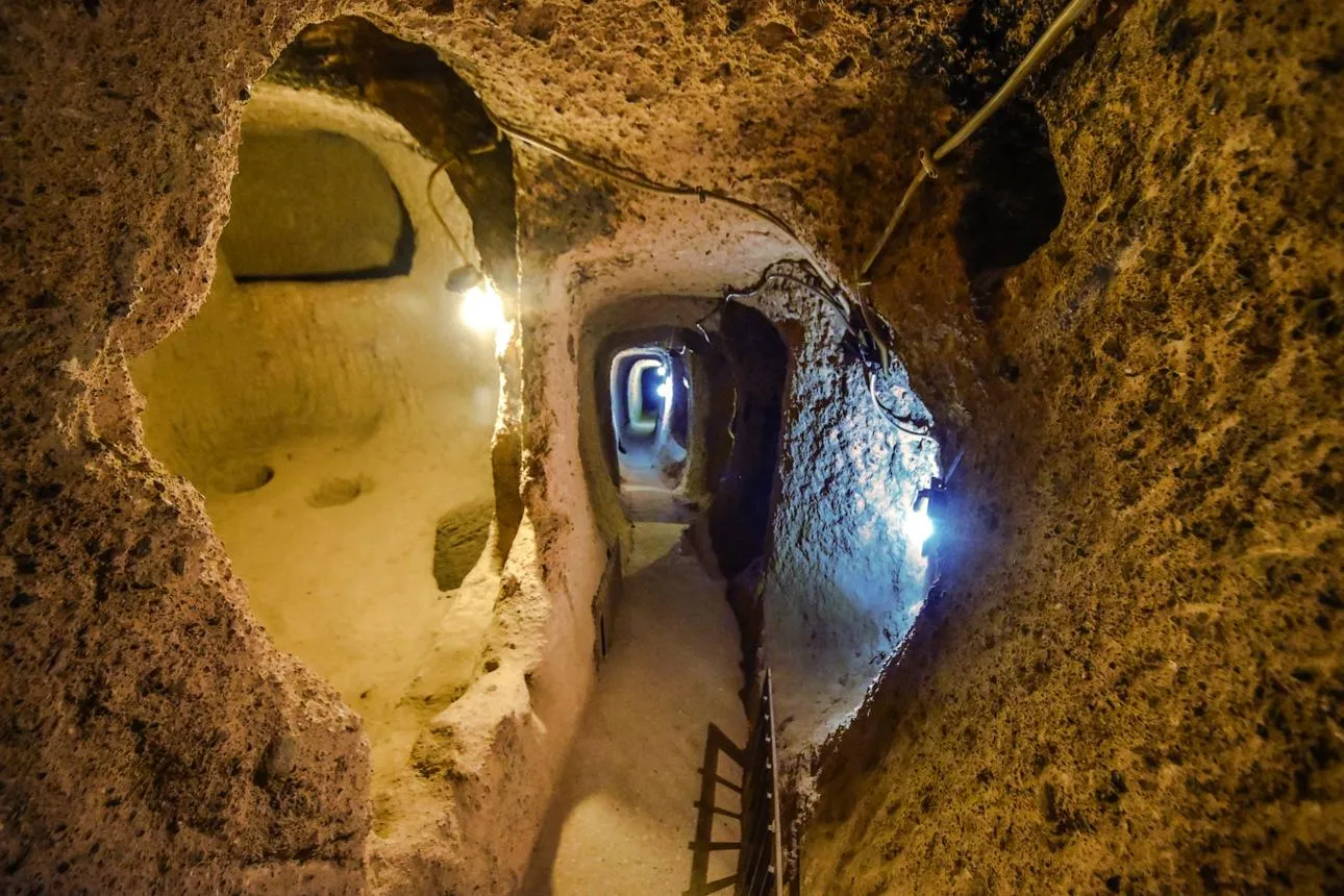 Narrow lit tunnels inside Kaymaklı Underground City