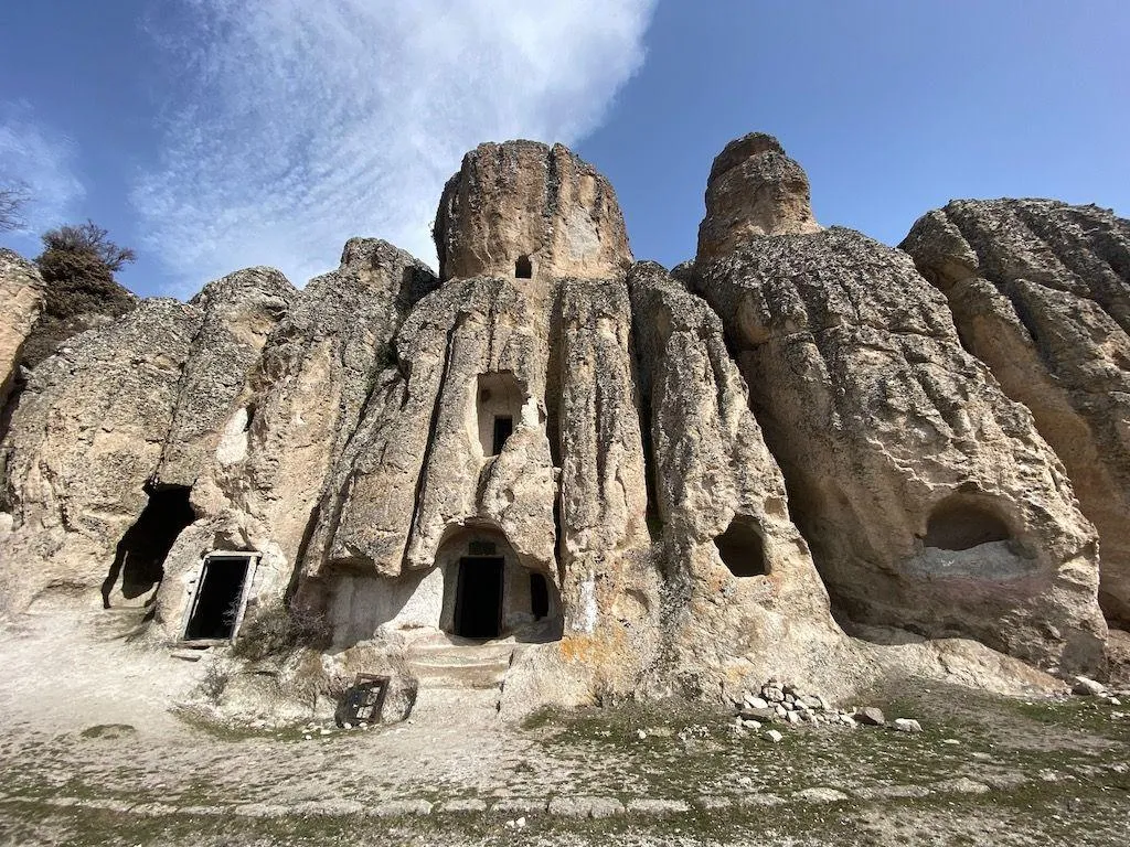 Rock formations carved with doorways and windows at Kilistra