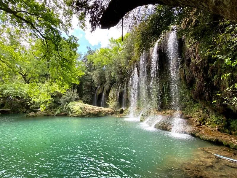 Kurşunlu Waterfall spilling into a clear green pool in the forest