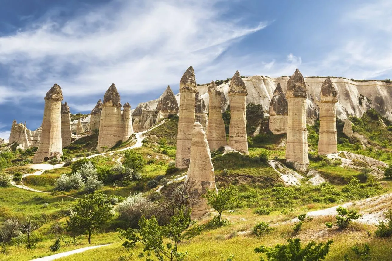 Tall rock pillars of Love Valley among green fields