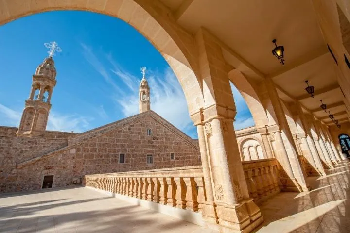 A stone arcade and church towers in the old town of Midyat