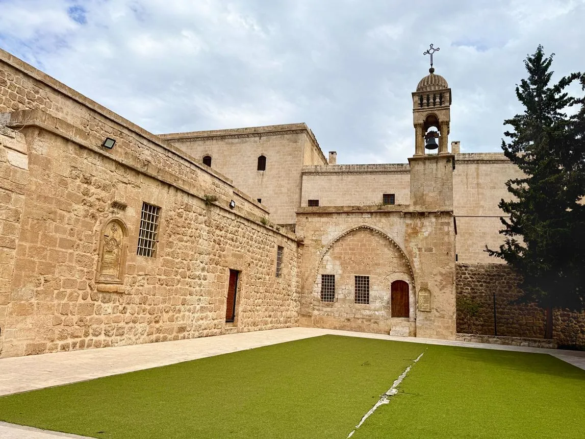 The stone walls and bell tower of Kırklar Church in Mardin