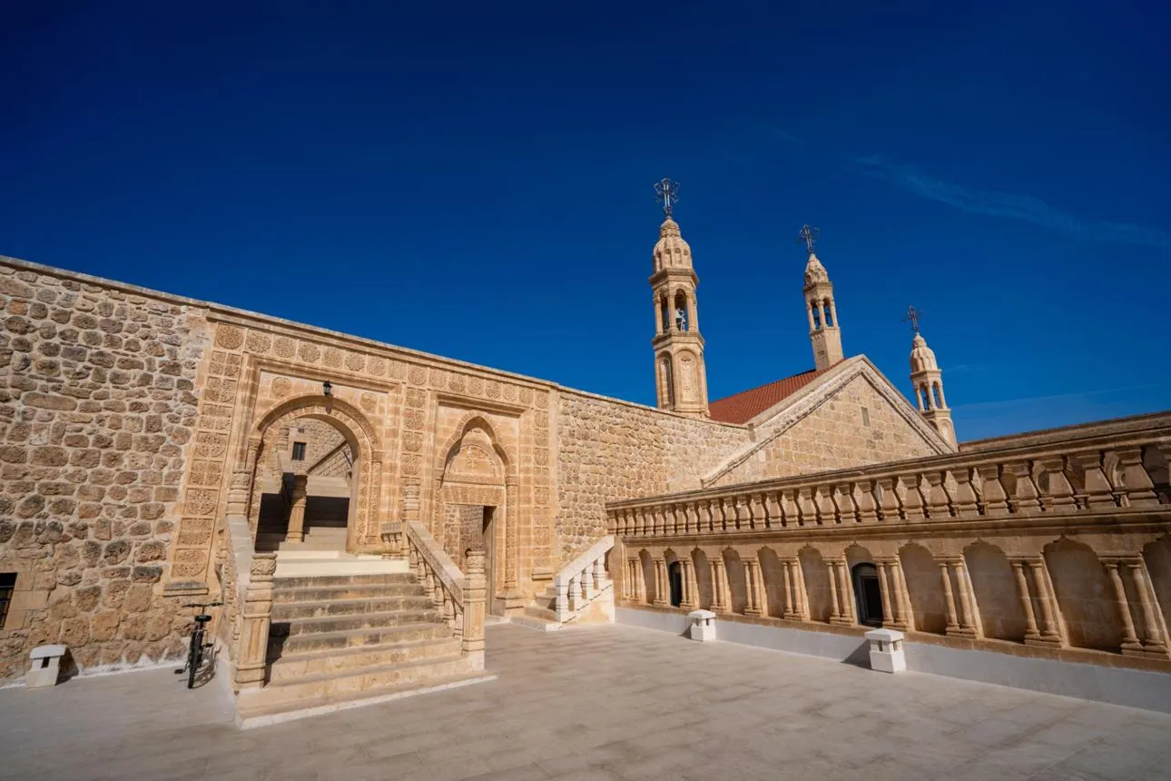 The stone courtyard, bell towers and arcades of Mor Gabriel Monastery
