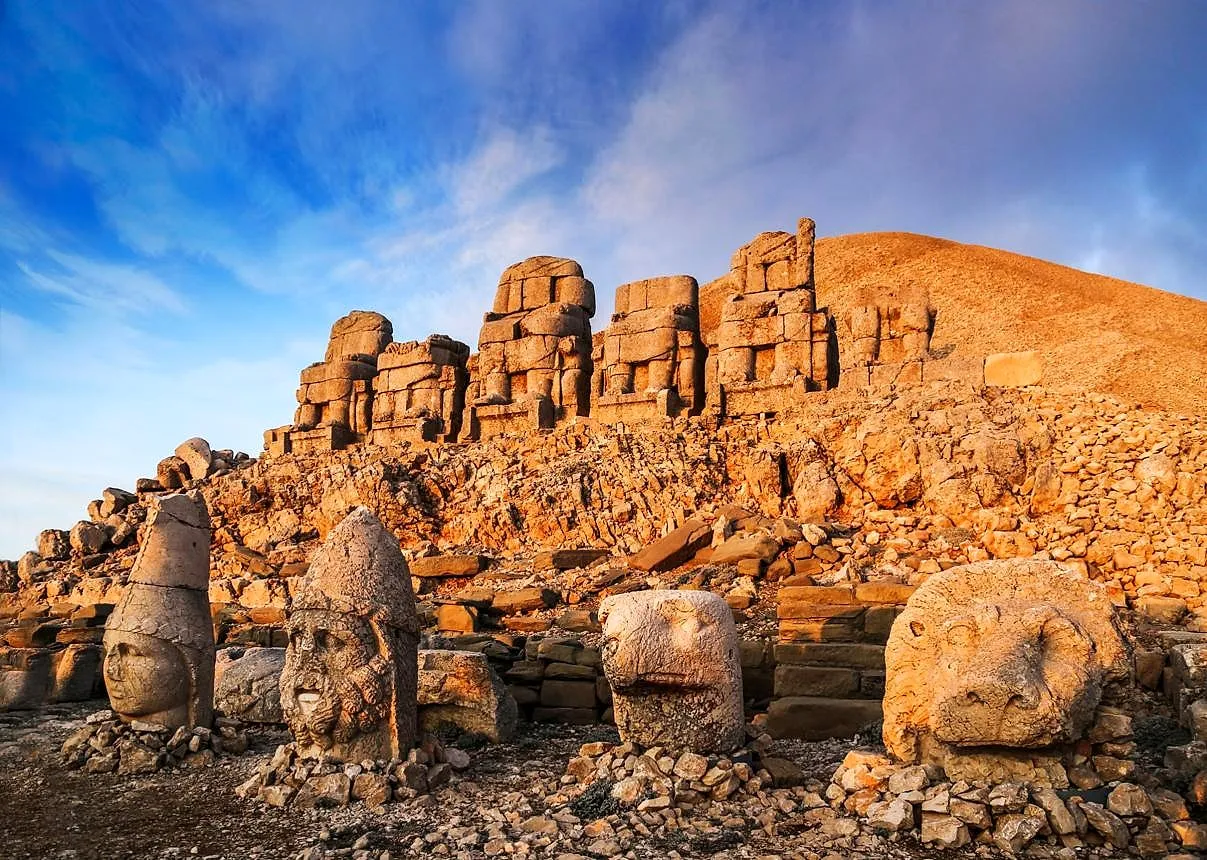 Colossal stone heads on Mount Nemrut in golden light