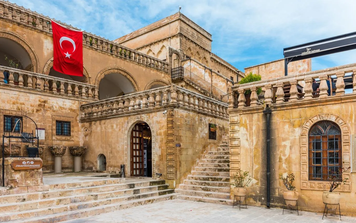 The stone courtyard, staircase and arches of the Mardin Museum
