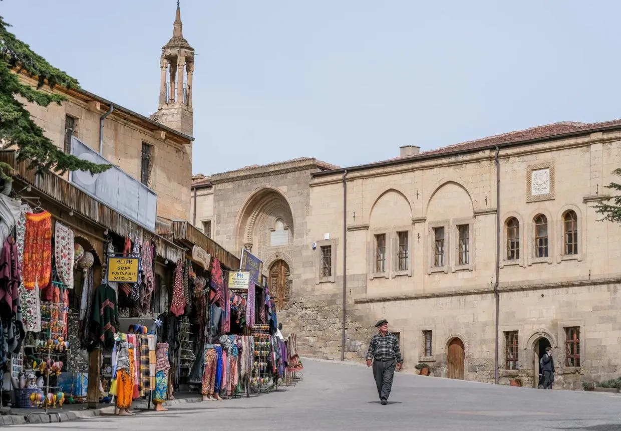 Stone buildings and a craft stall on the main square of Mustafapaşa