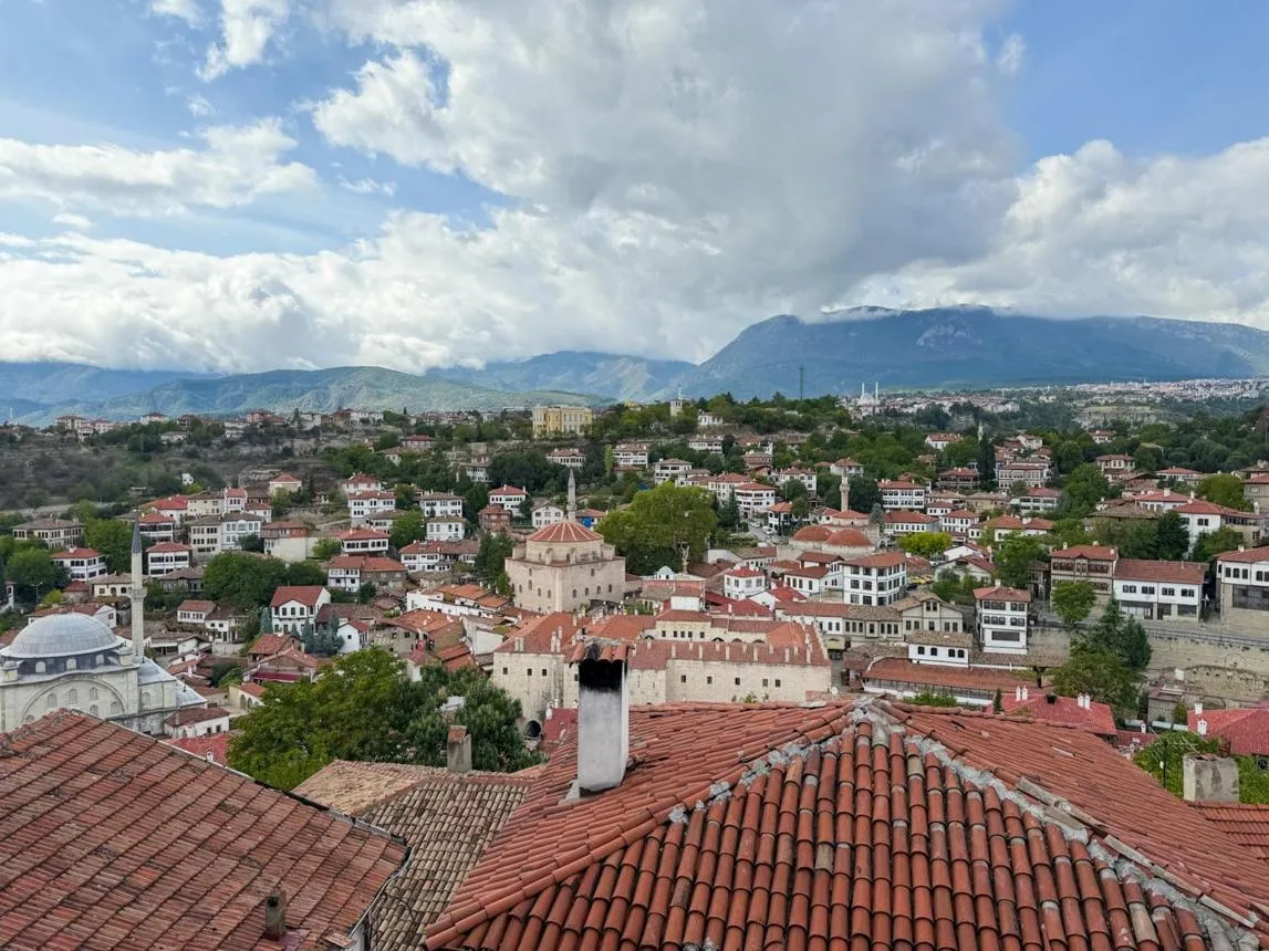 Red-tiled roofs and old houses of Safranbolu with mountains behind