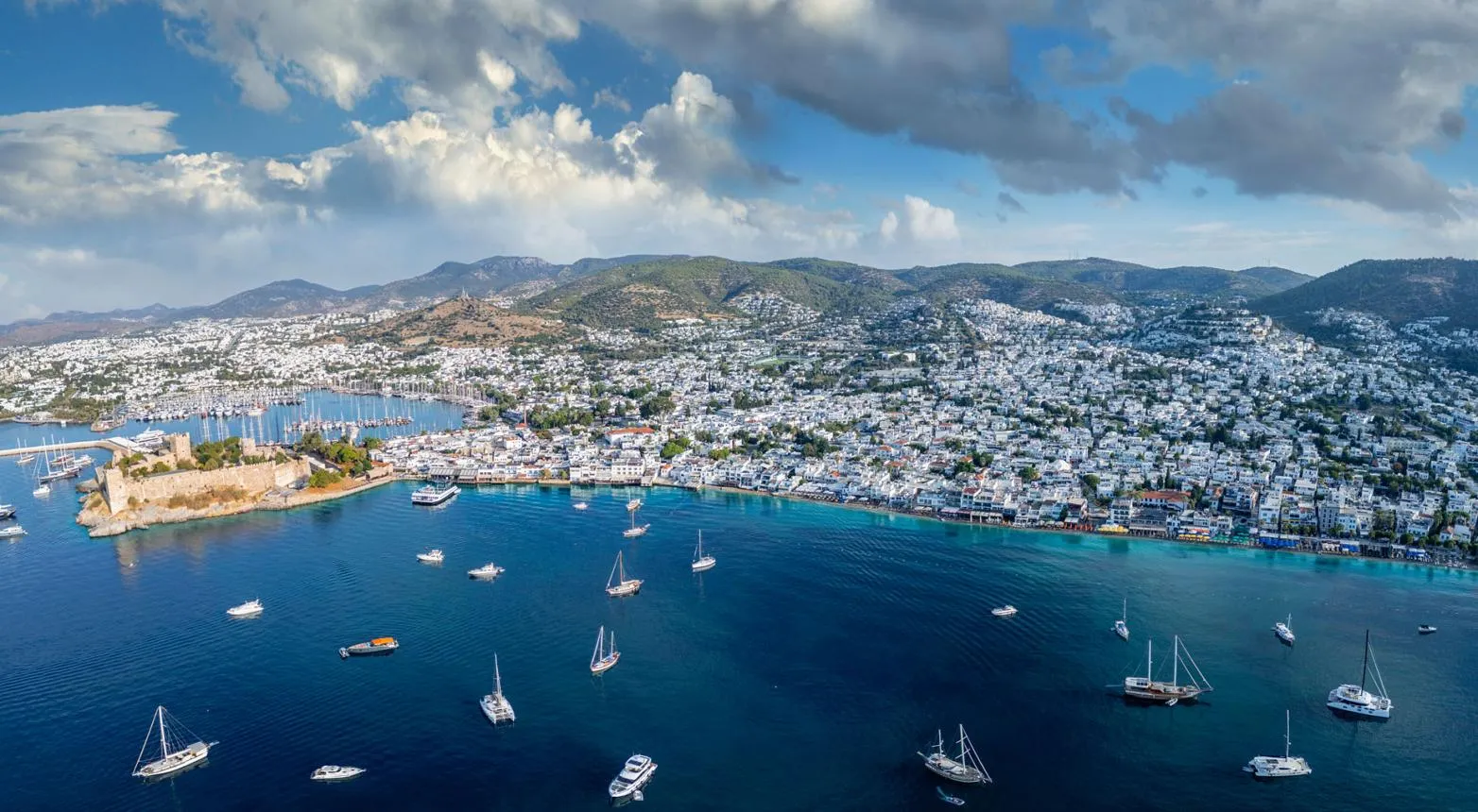 Panoramic view of Bodrum bay, the castle and the white town under summer clouds