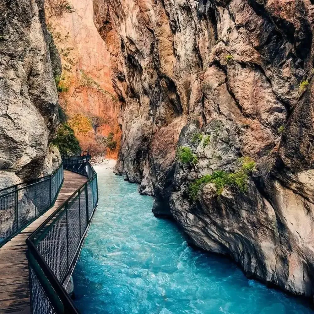 A boardwalk above the rushing turquoise river inside Saklıkent Gorge