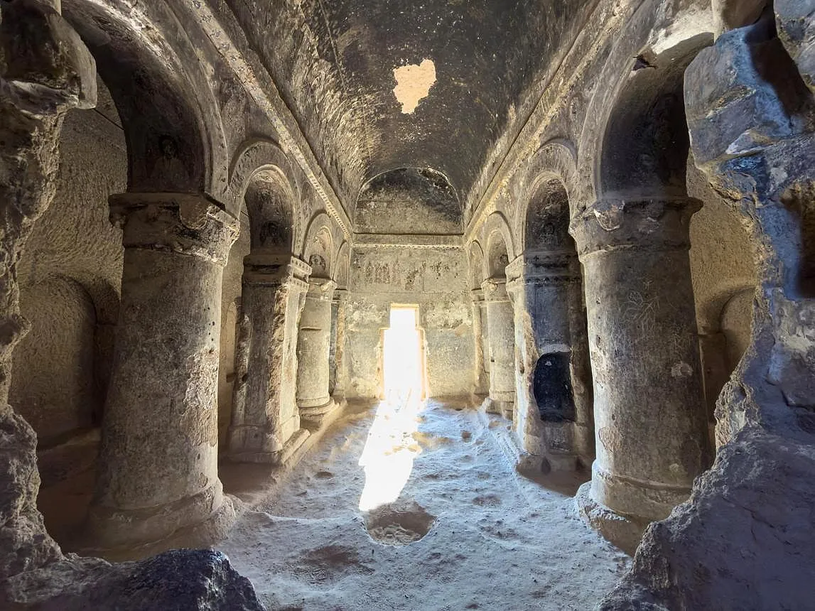 Carved pillars and arches inside the rock-cut cathedral of Selime