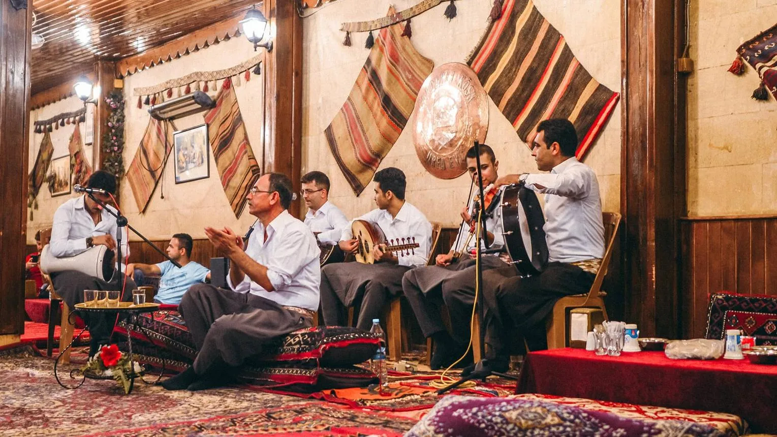 Musicians playing traditional instruments during a Sıra Gecesi evening
