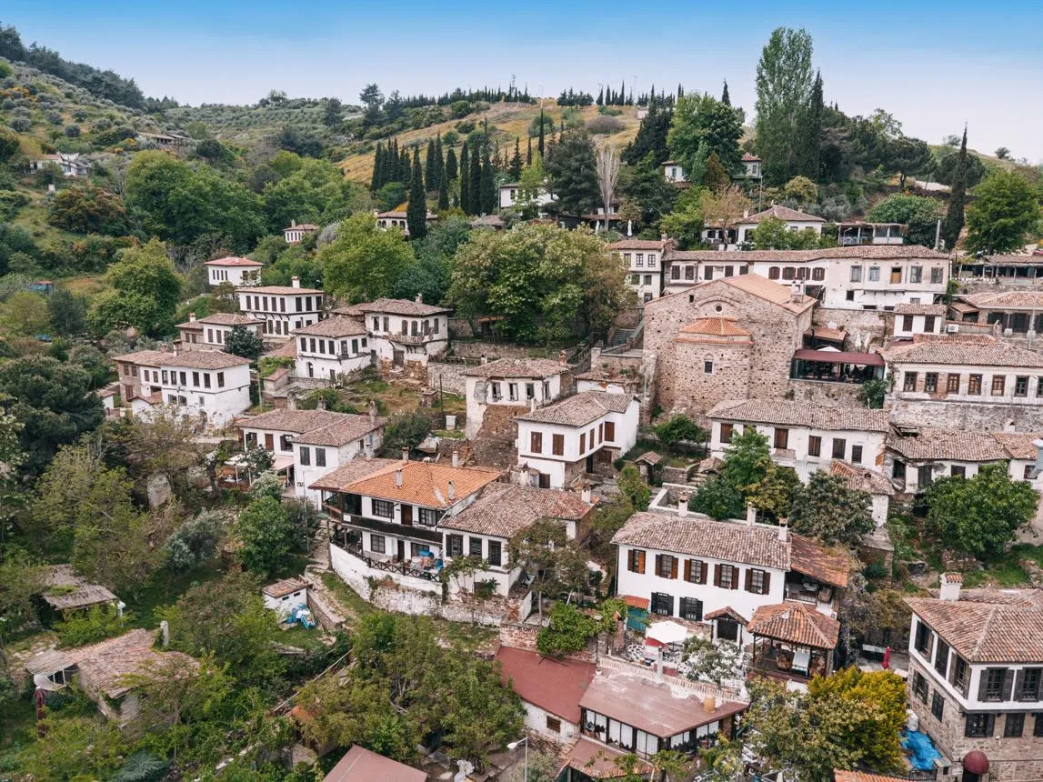 White houses and the old church of Şirince on a green hillside