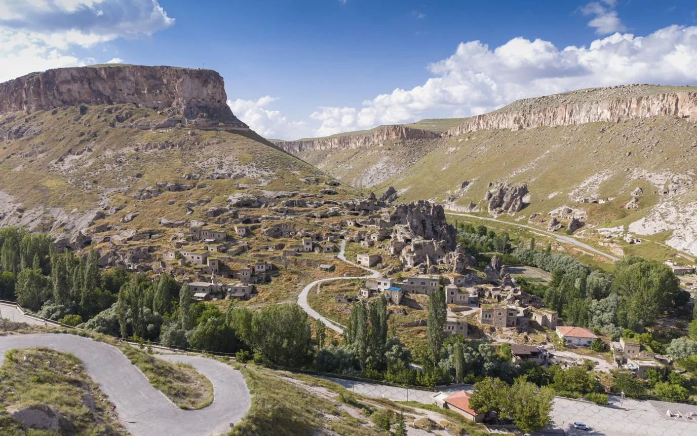 Soğanlı village and its cave dwellings below a flat-topped hill