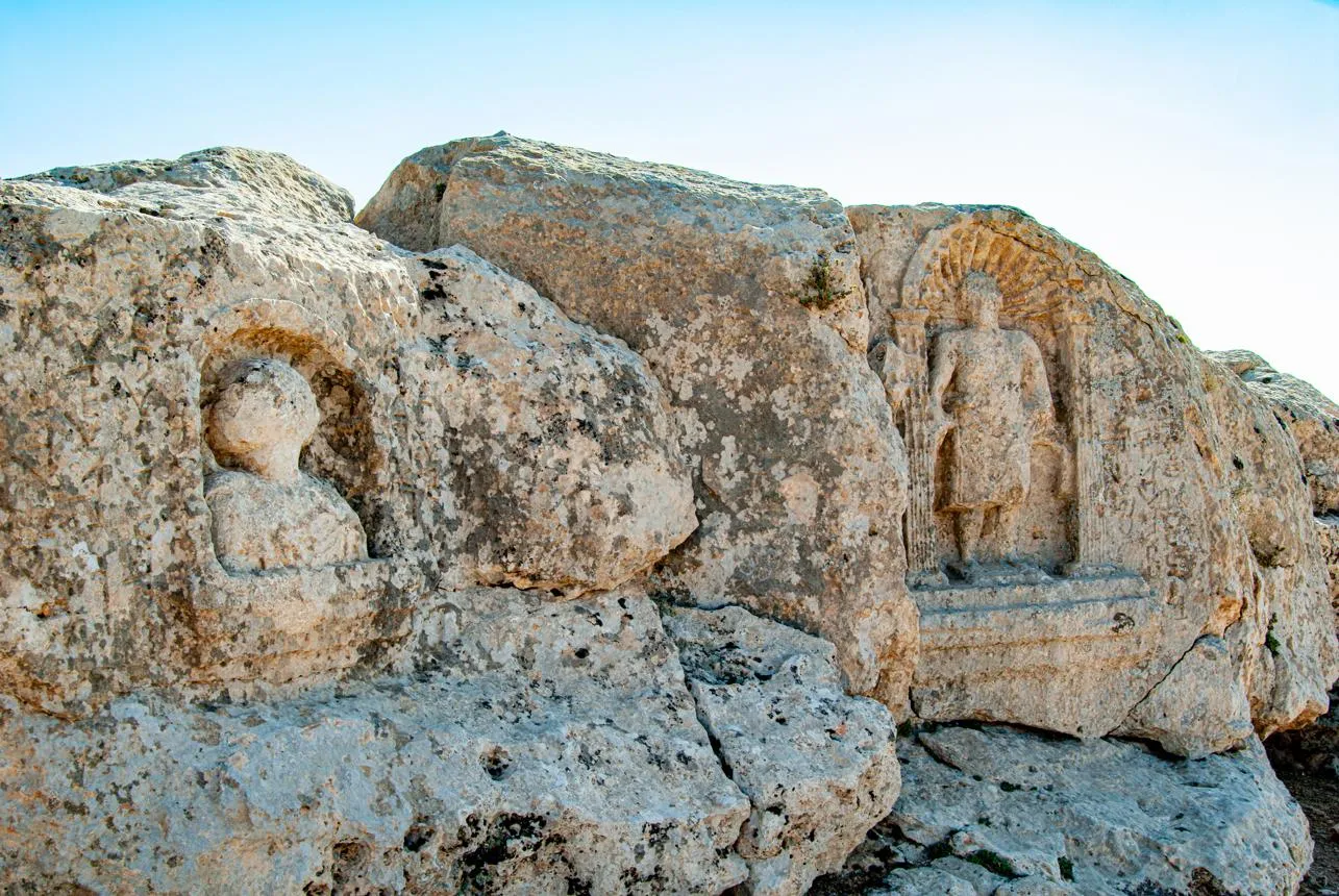 Carved figures in niches on the rock face at Soğmatar
