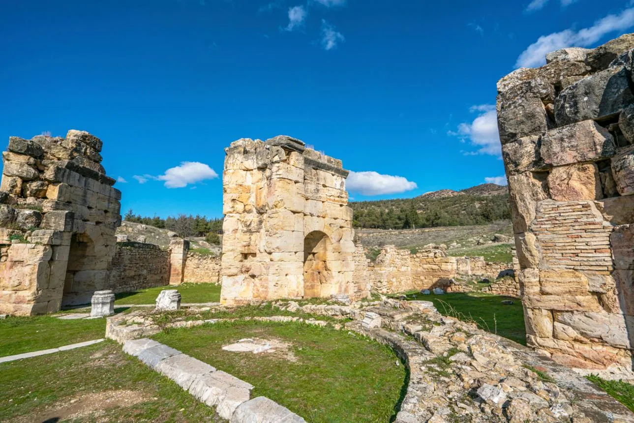 Stone walls and arches of St Philip's Martyrium on the hillside