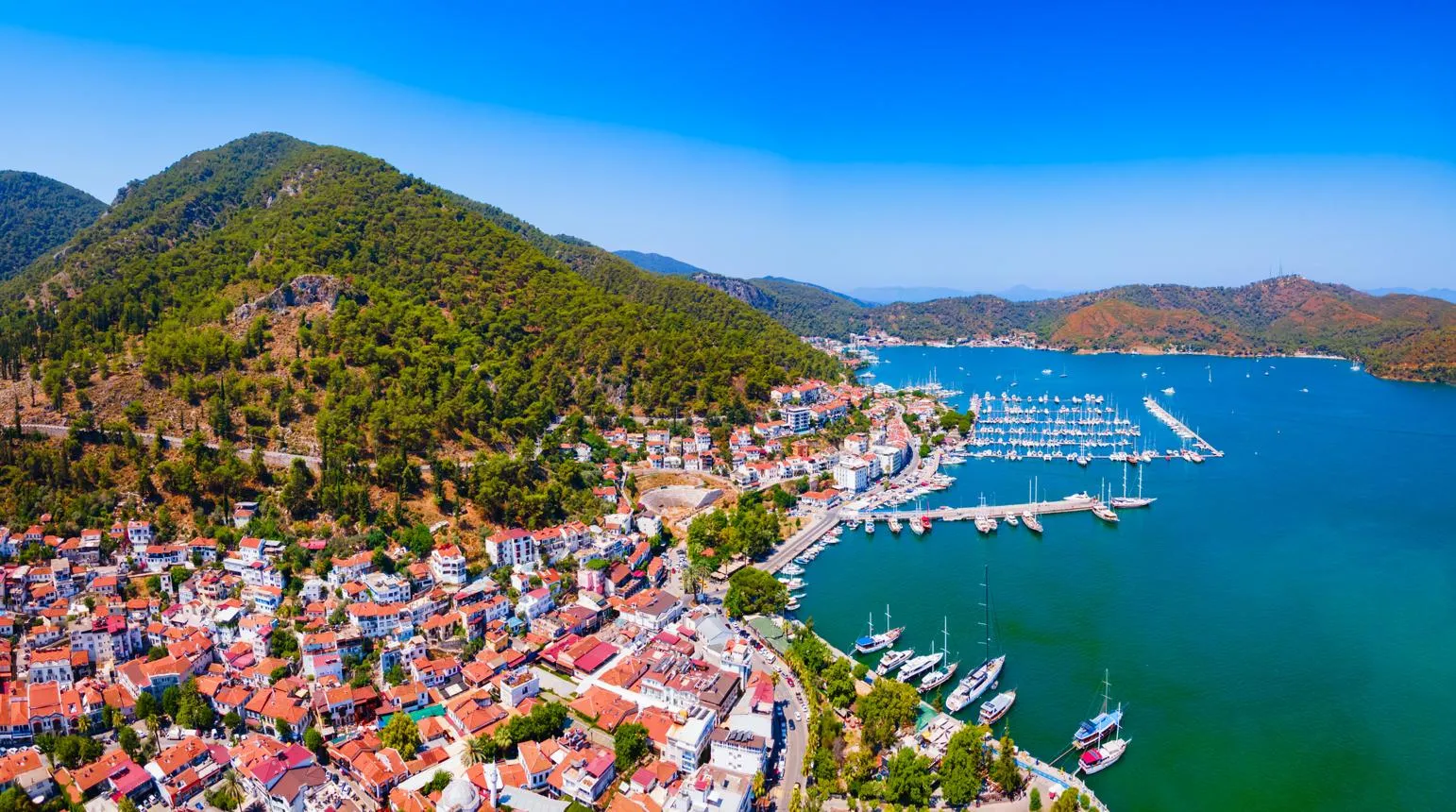 Aerial view of Fethiye town, its marina and the green hills around the bay