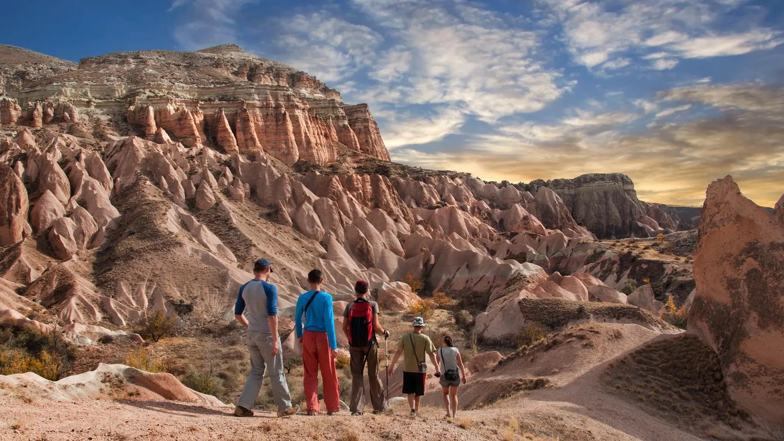 A group of hikers looking out over the rock formations of Red Valley