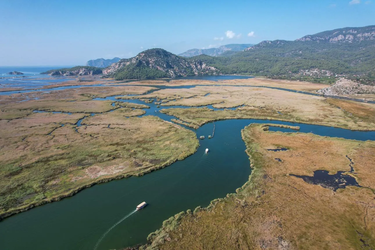 Aerial view of the river winding through the delta's marshes towards the hills